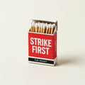 Red matchbook reading STRIKE FIRST in white with The Roast wordmark